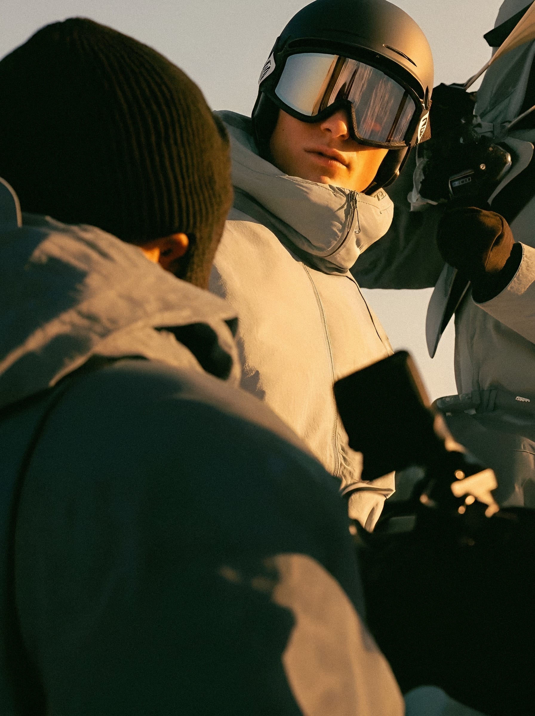 Figures in winter sports gear.