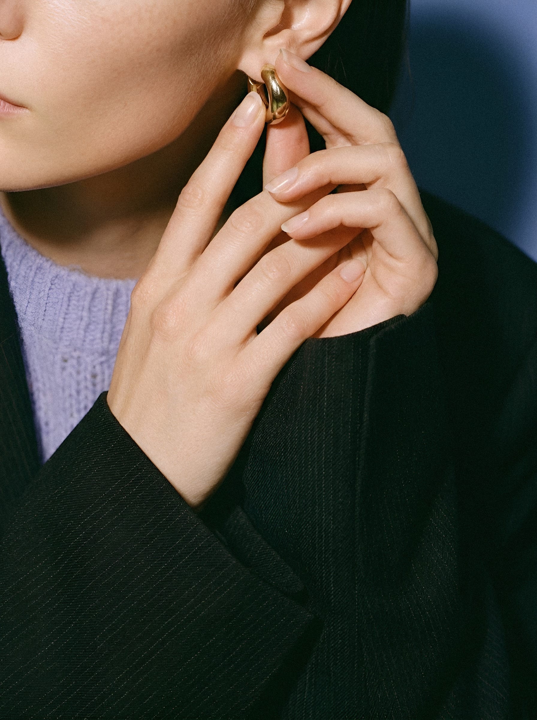 Gold hoop against ribbed knit.