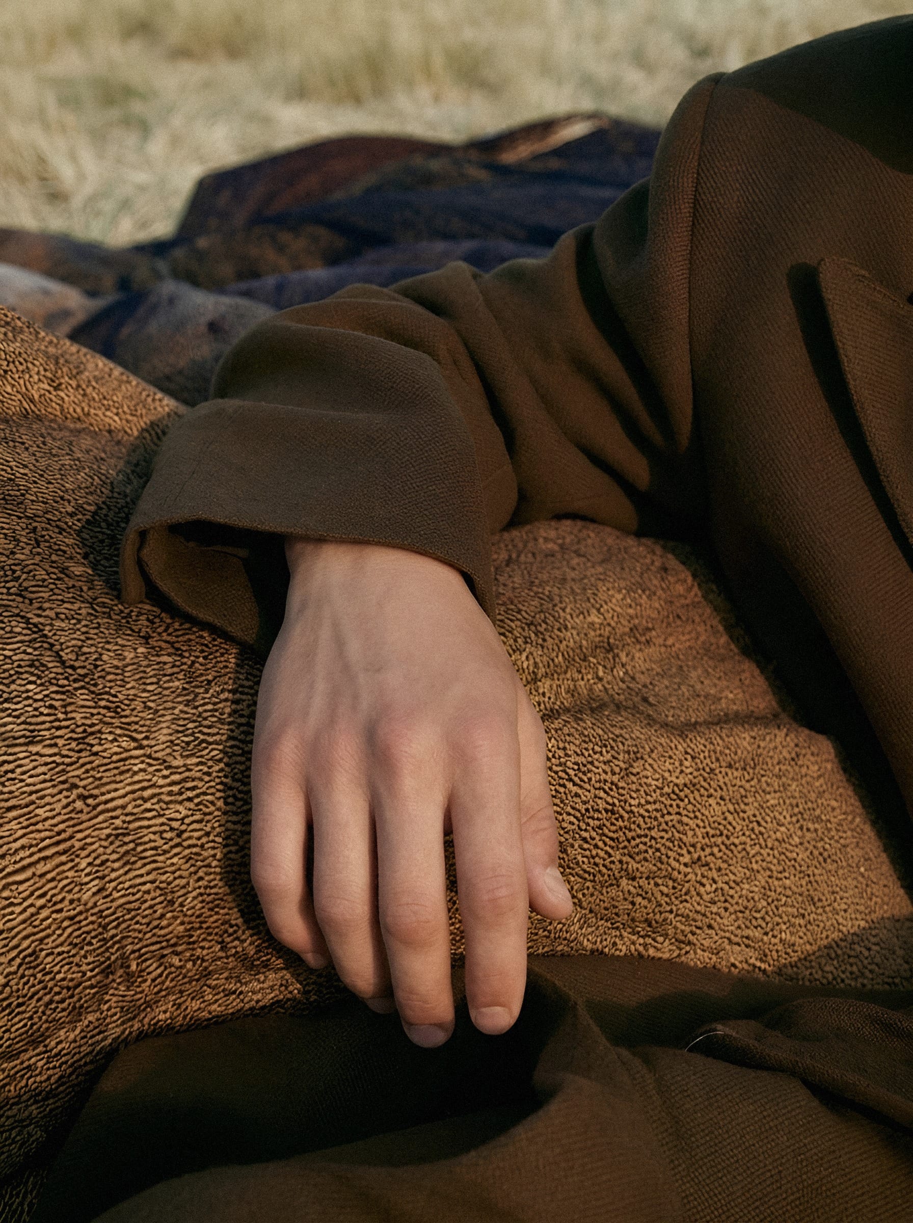 Hand on woven textile.