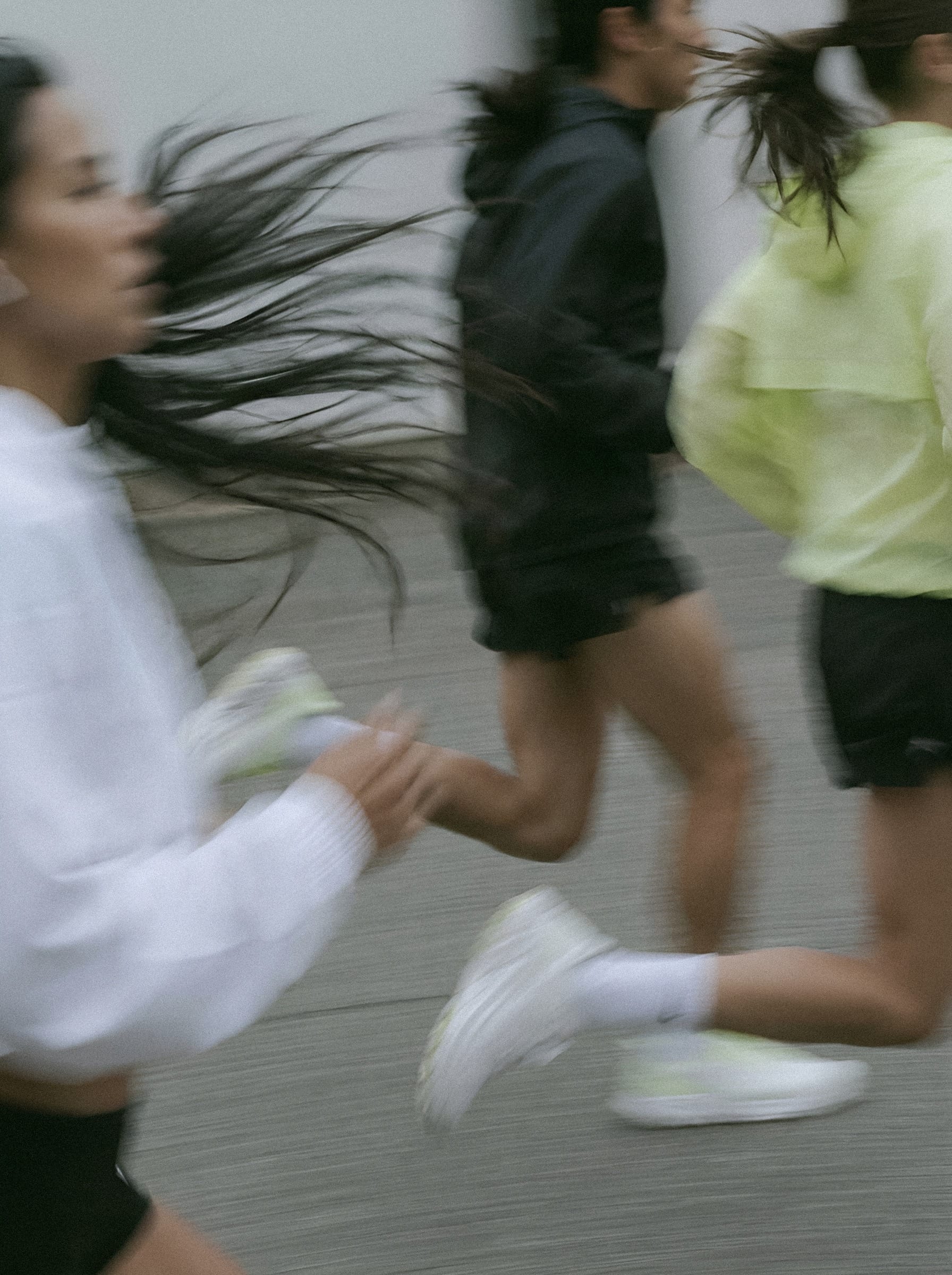 Runner in motion against grey.