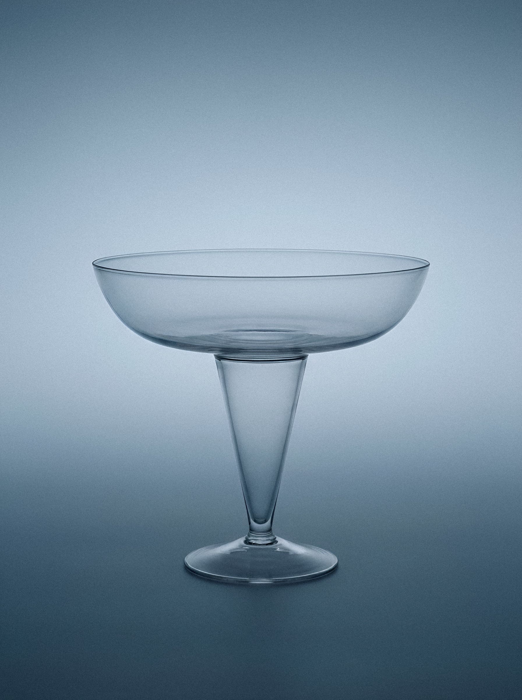 Stemmed glass on gradient ground.