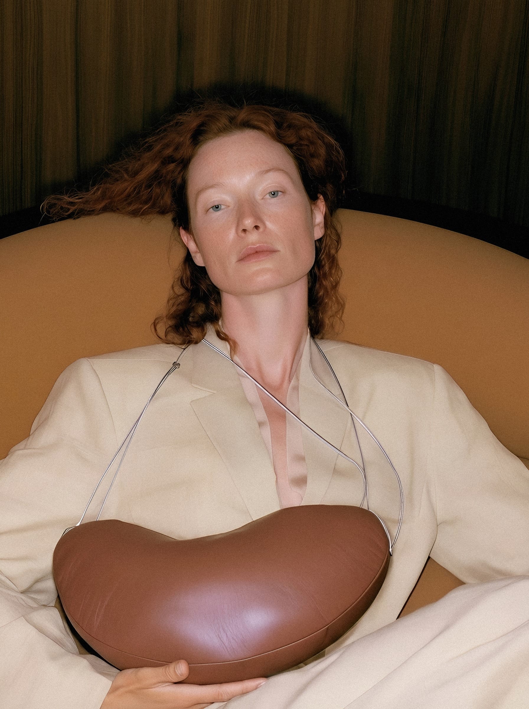Woman holding leather form.