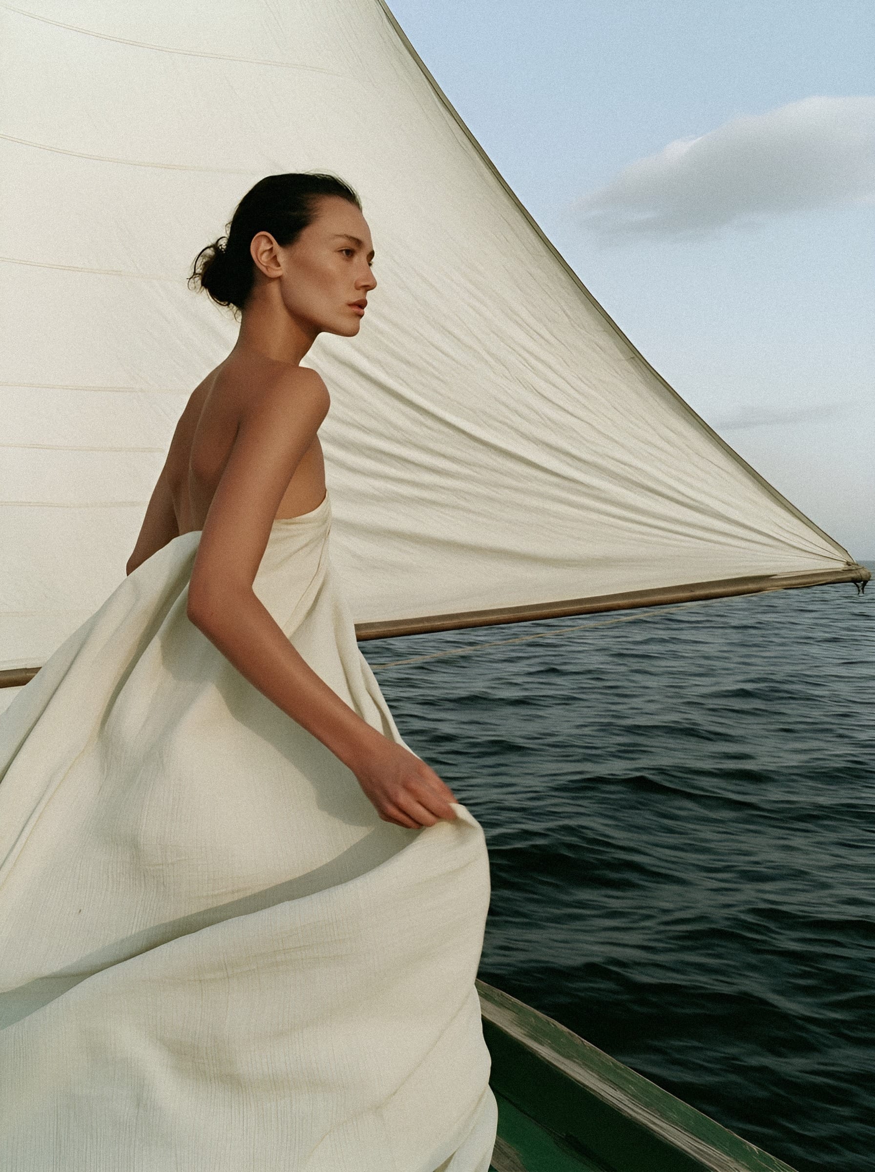 Woman in white linen at sail.