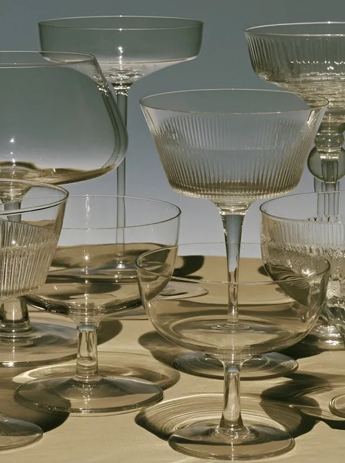 Glassware with ribbed stems and shadows.