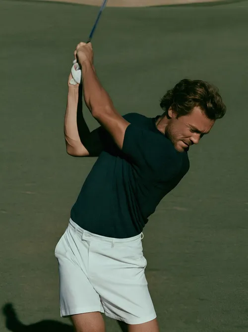 Golf swing mid motion.