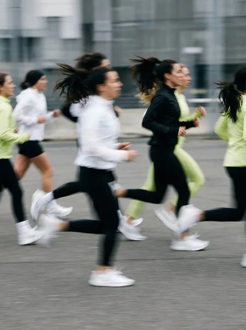 Group running across urban plaza.
