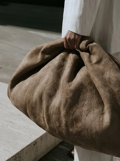 Linen bundle gathered in hand.