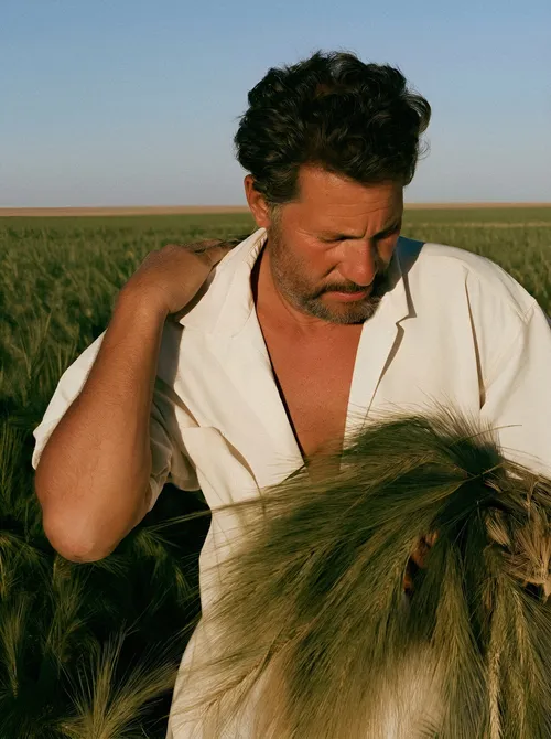 Man examining grain crop.
