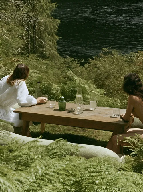 Picnic table by rippling water.