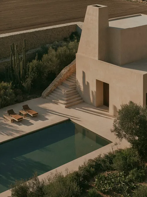 Terracotta courtyard with pool and stairs.