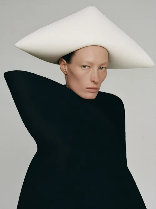 Woman in oversized white hat.