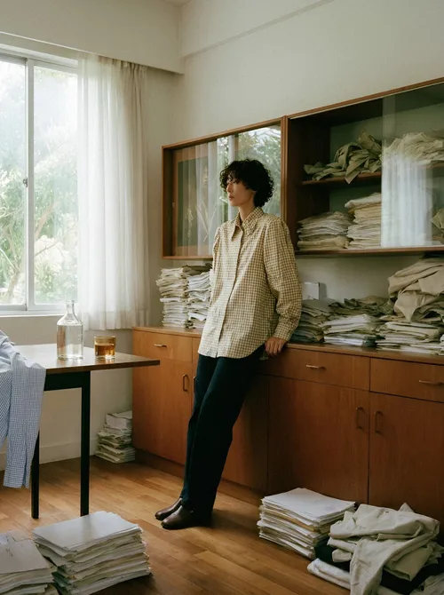 Woman standing before linen cabinet.
